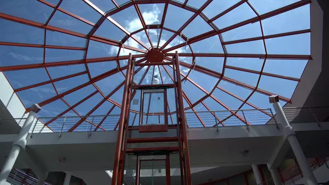 Atrio ampio e luminoso della sede centrale europea di KiK a Bönen, caratterizzato da una copertura in vetro